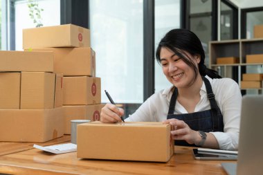 Asian entrepreneurs small business SME independent men work at home, online marketing, packing boxes, SME sellers, concept, e-commerce and online sales.