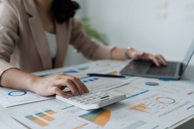 accountant using calculator and laptop computer in office, businessman working at home, finance and accounting concept