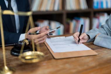 Business people negotiating a contract. Human hands working with documents at desk and signing contract.