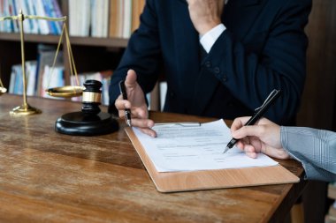 Business people negotiating a contract. Human hands working with documents at desk and signing contract.