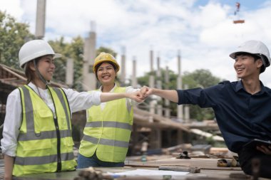 Engineers people join hands to build successful projects. Teamwork concept
