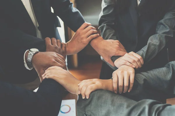 Group of diverse hands holding each other support together teamwork aerial view.