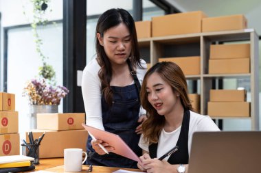 Starting small businesses SME owners, asian women check online orders Selling products working with boxs freelance work at home office, sme business online small medium enterprise.