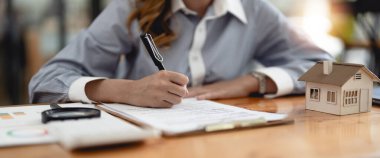 Real Estate agent explain signing agreement for buying house. Bank manager and real estate concept