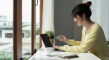 Online payment, Womans hands holding credit card and using laptop computer for online shopping