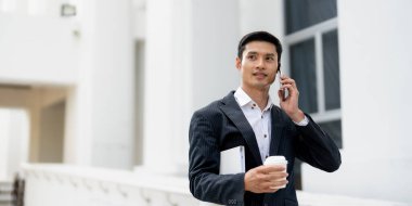 Handsome Asian businessman calling on smartphone. close up