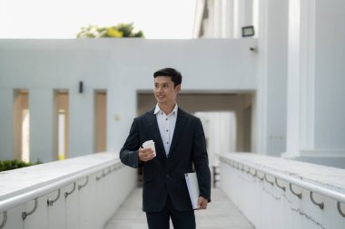 Portrait of young confident asian businessman outdoor