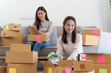 Partnership of SME entrepreneur teamwork of small business online marketing with packing box prepare for deliverty to customers at warehouse home seller office