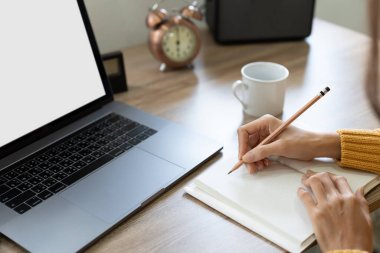 asian female student watching lesson online and studying distantly. Young woman takes notes, listening lecture from female teacher on video call.Video conference with teacher and students