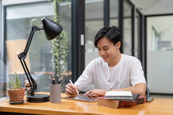 Happy smiling asian student using digital tablet computer. Online learning education concept