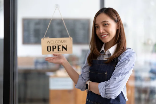 Welcome open shop barista waitress open sign on glass door modern coffee shop ready to serve restaurant cafe retail small business owners