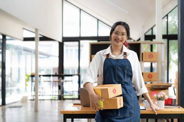 Başlangıçta küçük işletme girişimcisi KOBİ serbest kadın kutuyla çalışıyor, Genç Asyalı çevrimiçi pazar paketleme kutusu teslimatı, KOBİ e-ticaret tele pazarlama konsepti