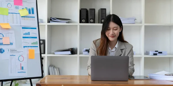 Beauitul young business asian woman working using computer laptop concentrated and smiling.