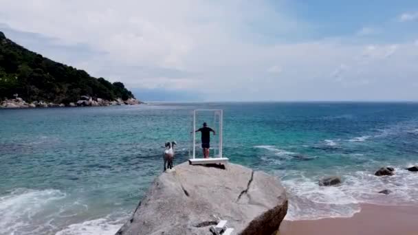 Guy Stands Stone Opens Window Shutters Overlooking Sea — Stock Video