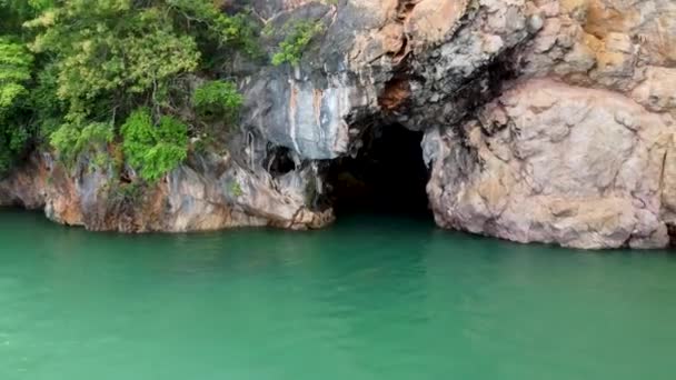 지방의 석회암 절벽에 동굴들은 식물로 뒤덮인 섬에서 물만을 이용한다 — 비디오