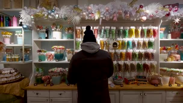 Man Chooses Sweets Candies Caramel Shop — стоковое видео