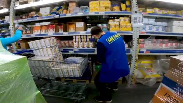 Supermarket Employee Lays Out Goods Cart Shelves — Stockvideo