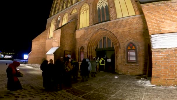 2021年12月25日 俄罗斯 加里宁格勒 晚上在康德大教堂门口排队参加音乐会的人群 — 图库视频影像