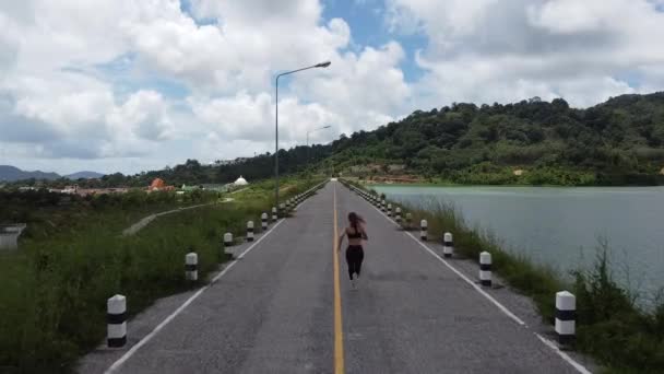 Girl Sportswear Runs Road Dam View Drone — Stock Video