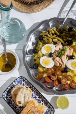 Ton balıklı patates salatası, haşlanmış yumurta, yeşil fasulye, vişneli domates ve salata soslu zeytin.