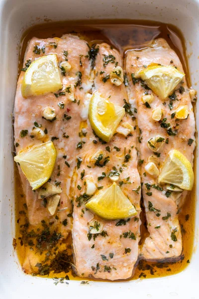 Baked salmon loins with olive oil, honey and garlic. Mediterranean and healthy cuisine