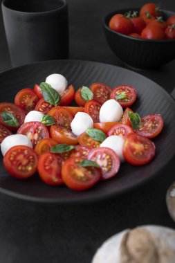 Cherry tomato salad with mozzarella cheese and fresh basil. Delicious caprese salad
