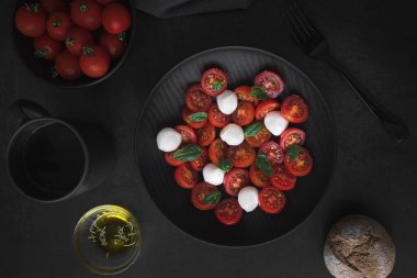 Cherry tomato salad with mozzarella cheese and fresh basil. Delicious caprese salad