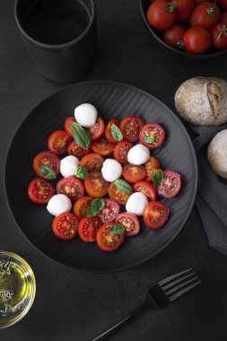 Cherry tomato salad with mozzarella cheese and fresh basil. Delicious caprese salad
