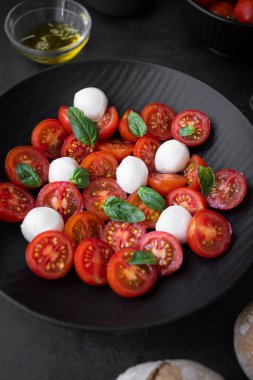 Cherry tomato salad with mozzarella cheese and fresh basil. Delicious caprese salad