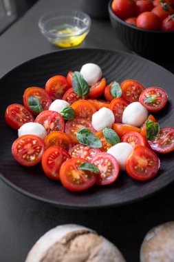 Cherry tomato salad with mozzarella cheese and fresh basil. Delicious caprese salad
