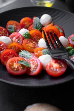 Cherry tomato salad with mozzarella cheese and fresh basil. Delicious caprese salad