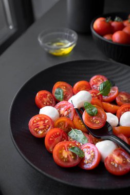Cherry tomato salad with mozzarella cheese and fresh basil. Delicious caprese salad