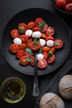 Cherry tomato salad with mozzarella cheese and fresh basil. Delicious caprese salad