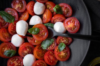 Cherry tomato salad with mozzarella cheese and fresh basil. Delicious caprese salad