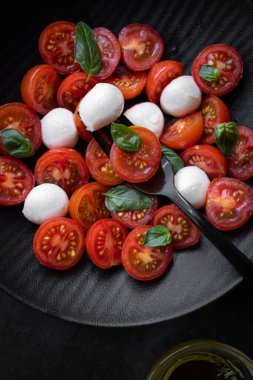 Cherry tomato salad with mozzarella cheese and fresh basil. Delicious caprese salad