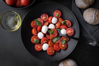 Cherry tomato salad with mozzarella cheese and fresh basil. Delicious caprese salad