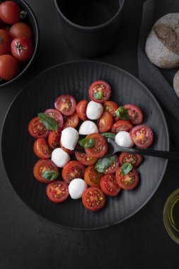 Cherry tomato salad with mozzarella cheese and fresh basil. Delicious caprese salad