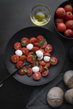 Cherry tomato salad with mozzarella cheese and fresh basil. Delicious caprese salad