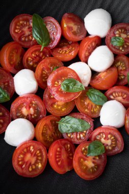 Cherry tomato salad with mozzarella cheese and fresh basil. Delicious caprese salad