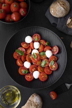 Cherry tomato salad with mozzarella cheese and fresh basil. Delicious caprese salad