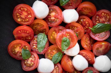 Cherry tomato salad with mozzarella cheese and fresh basil. Delicious caprese salad