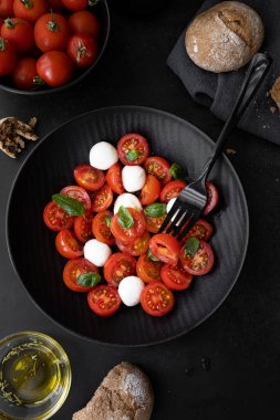 Cherry tomato salad with mozzarella cheese and fresh basil. Delicious caprese salad