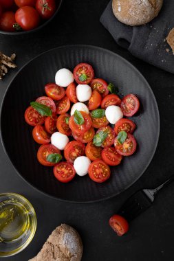 Cherry tomato salad with mozzarella cheese and fresh basil. Delicious caprese salad