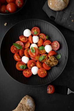 Cherry tomato salad with mozzarella cheese and fresh basil. Delicious caprese salad