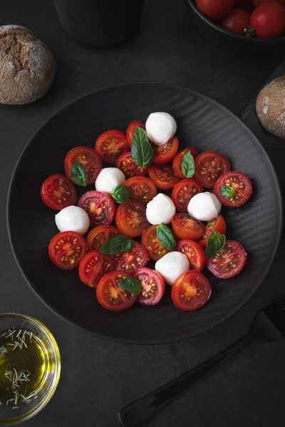 Cherry tomato salad with mozzarella cheese and fresh basil. Delicious caprese salad