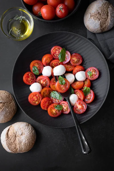 Cherry tomato salad with mozzarella cheese and fresh basil. Delicious caprese salad