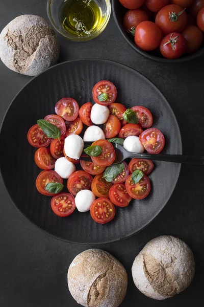 Cherry tomato salad with mozzarella cheese and fresh basil. Delicious caprese salad