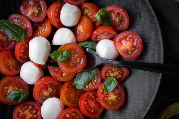 Cherry tomato salad with mozzarella cheese and fresh basil. Delicious caprese salad