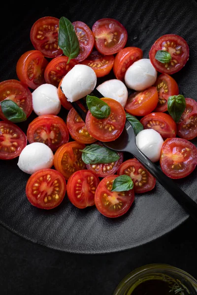 Cherry tomato salad with mozzarella cheese and fresh basil. Delicious caprese salad