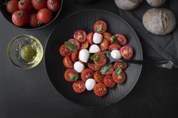 Cherry tomato salad with mozzarella cheese and fresh basil. Delicious caprese salad